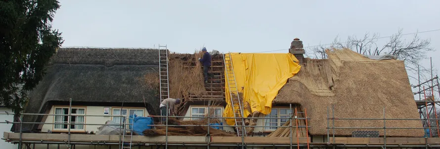 Water reed re-thatch in progress at Pirton, Hertfordshire