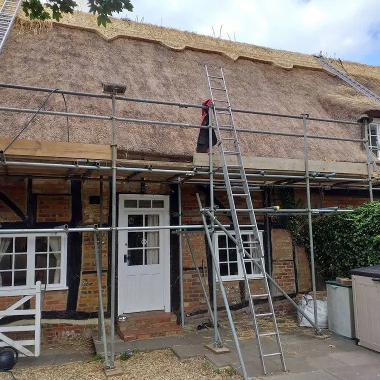 Re-thatch in progress on a timber-framed cottage, 2020